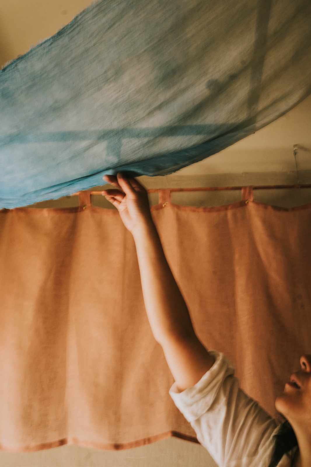 Yurika Saito's indigo-dyed cloth being hung in the tea room