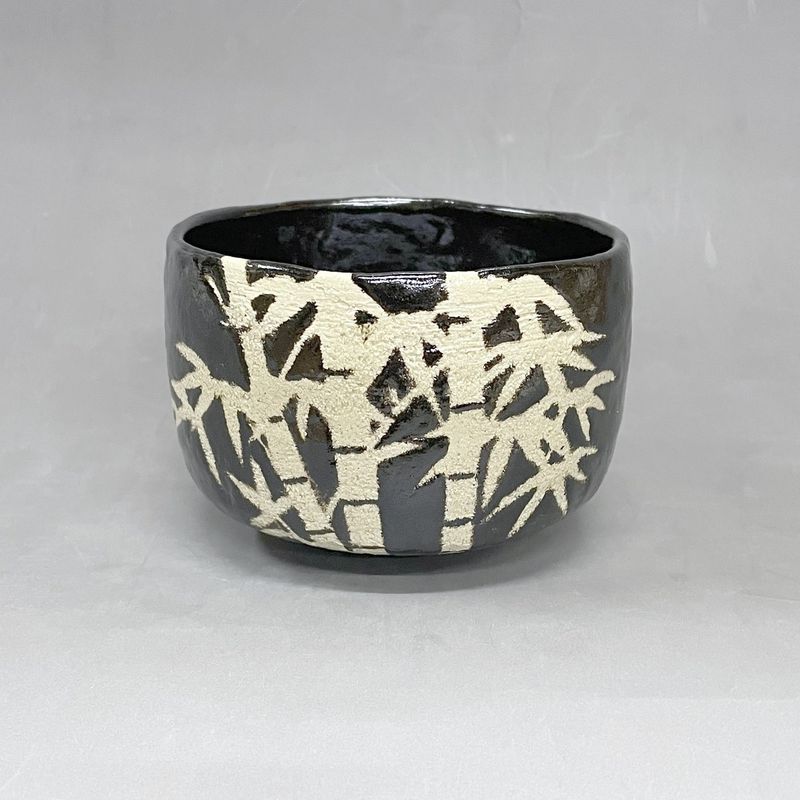 Bamboo Forest: a black Raku tea bowl with white bamboo stems and leaves