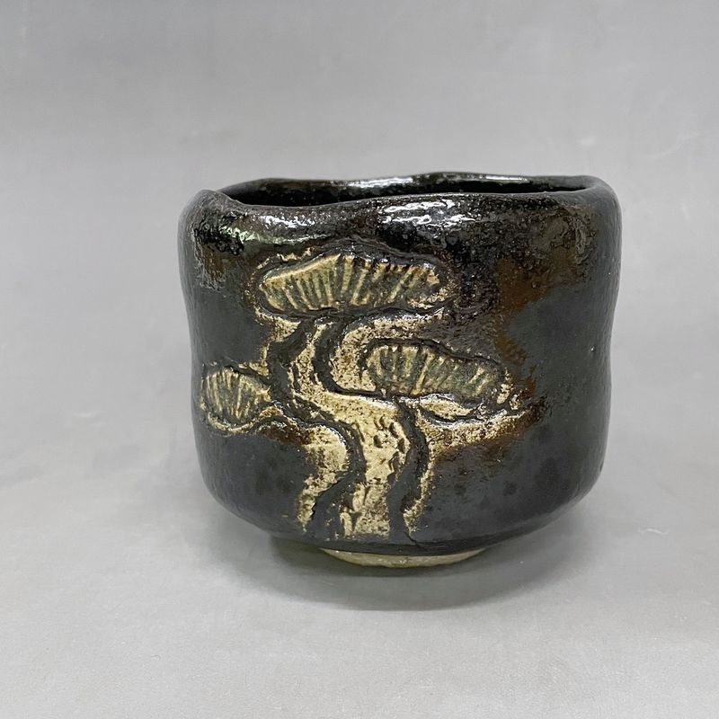Old Pine Black: a black Raku tea bowl with an old pine tree