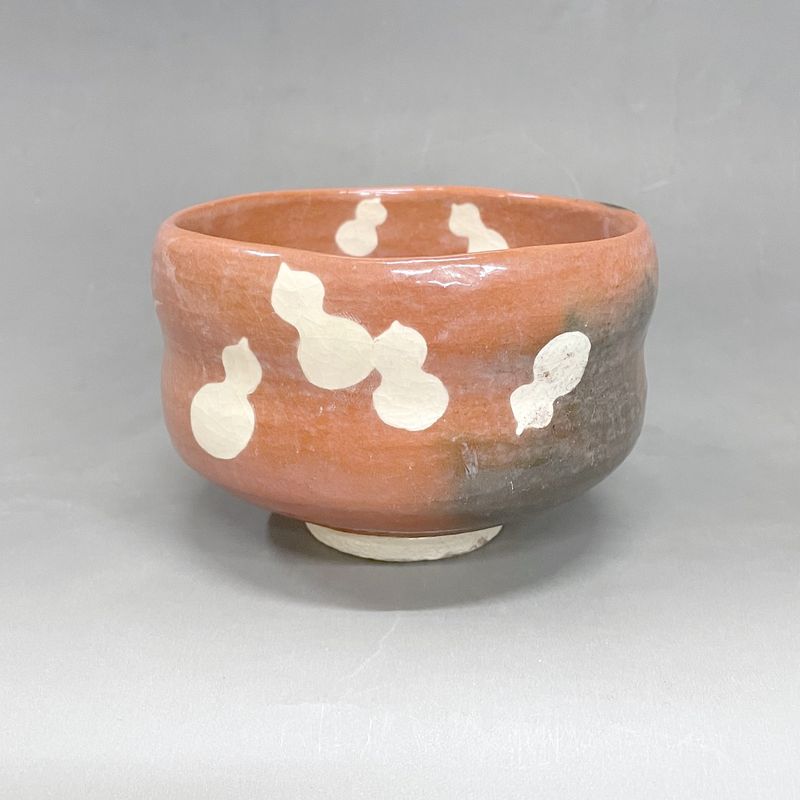 Six Gourds: a red Raku tea bowl painted with white gourds