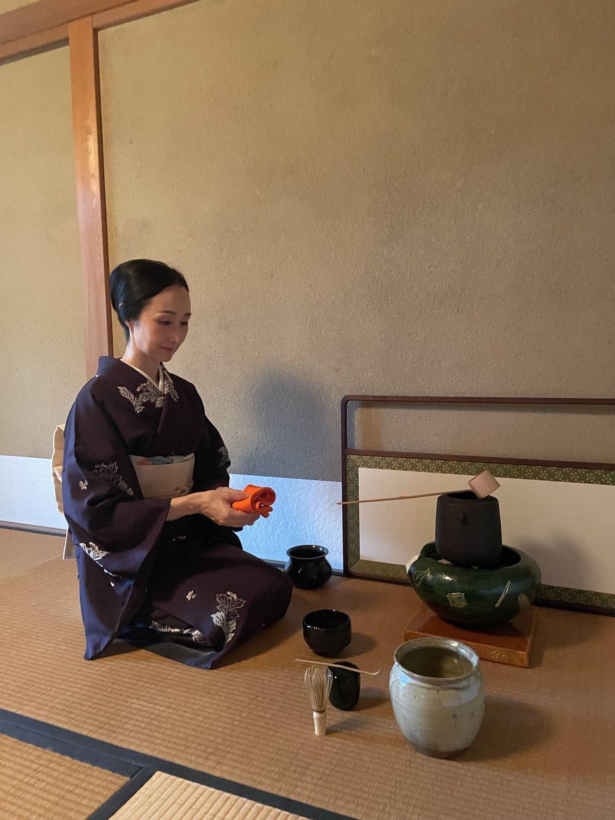 Rumi Higaki in kimono, kneeling in the tea room at Katsura-gama, a kettle and bowls beside her